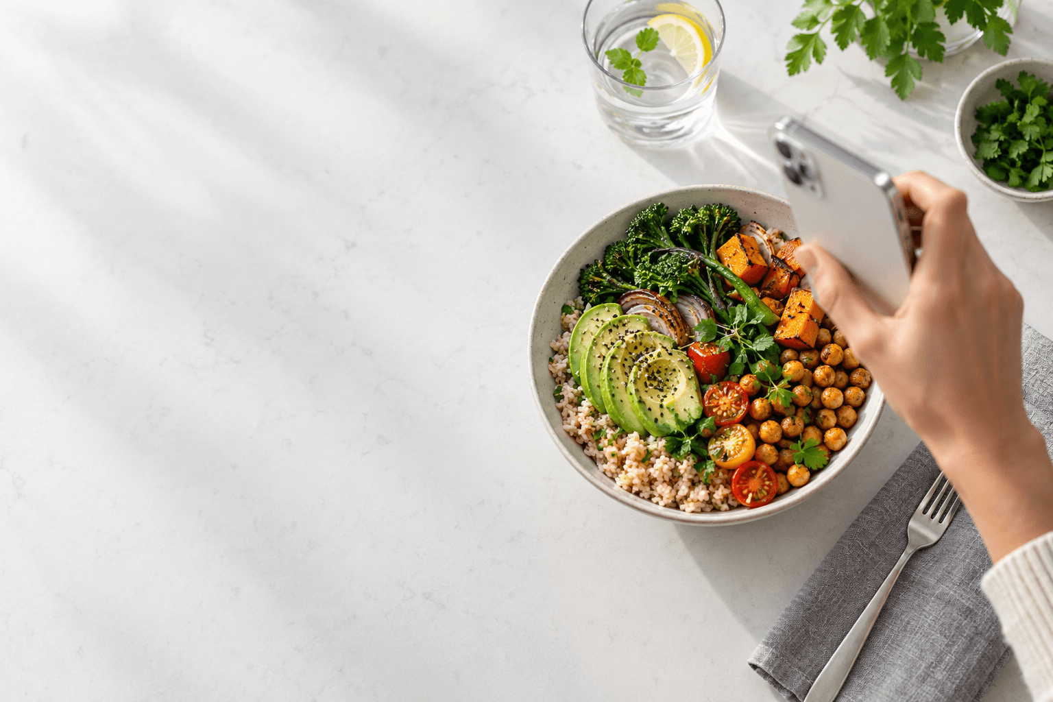 A phone held above a colorful lunch