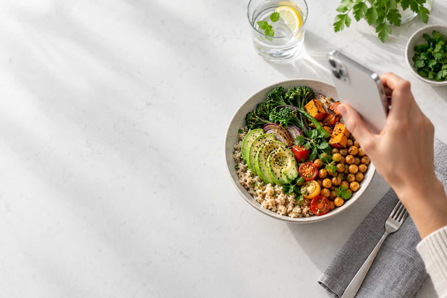A phone capturing a colorful lunch on a light table